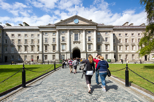 Dublin, Ireland - May 19th, 2011: One of the greatest Dublin landmarks Trinity College. A lot of tourists and students can be seen entering and leaving the campus.