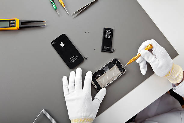 Iphone 4 repairing "Istanbul, Turkey - February 26, 2011: The process of reparation of Iphone which authorized by technician.The cellular phone is produced by Apple Computer, Inc.." repair iPhone stock pictures, royalty-free photos & images