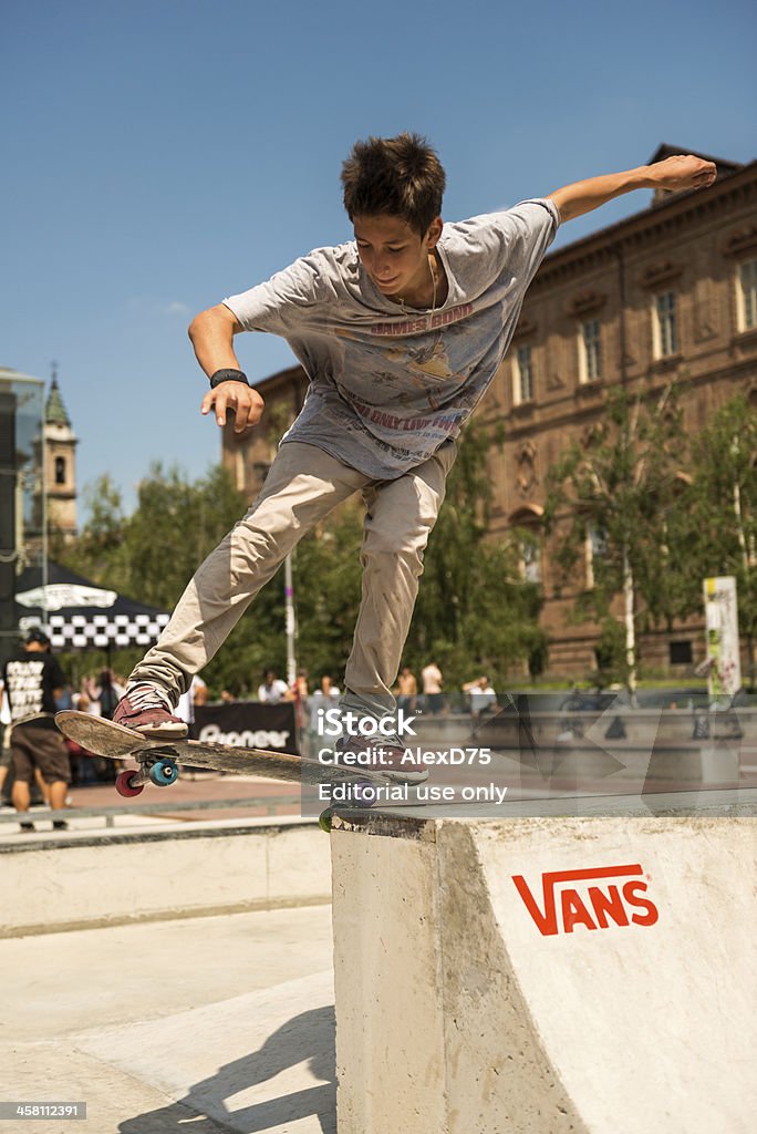 Skateboarder in Turin "Turin, Italy - July 14, 2012: Skate boarder in Turin - A young student skateboarder perform a figure with his board at brand new skate park in center of Turin" Activity Stock Photo