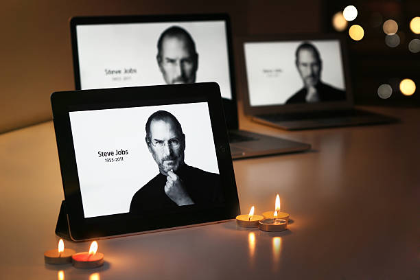 STEVE JOBS displays on Apple products "Riyadh Saudi Arabia - September 24, 2012: An iPad displays Steve Jobs, alongside candles, offer a simple goodbye to the former CEO of Apple Inc, Steve Jobs." apple computers photos stock pictures, royalty-free photos & images
