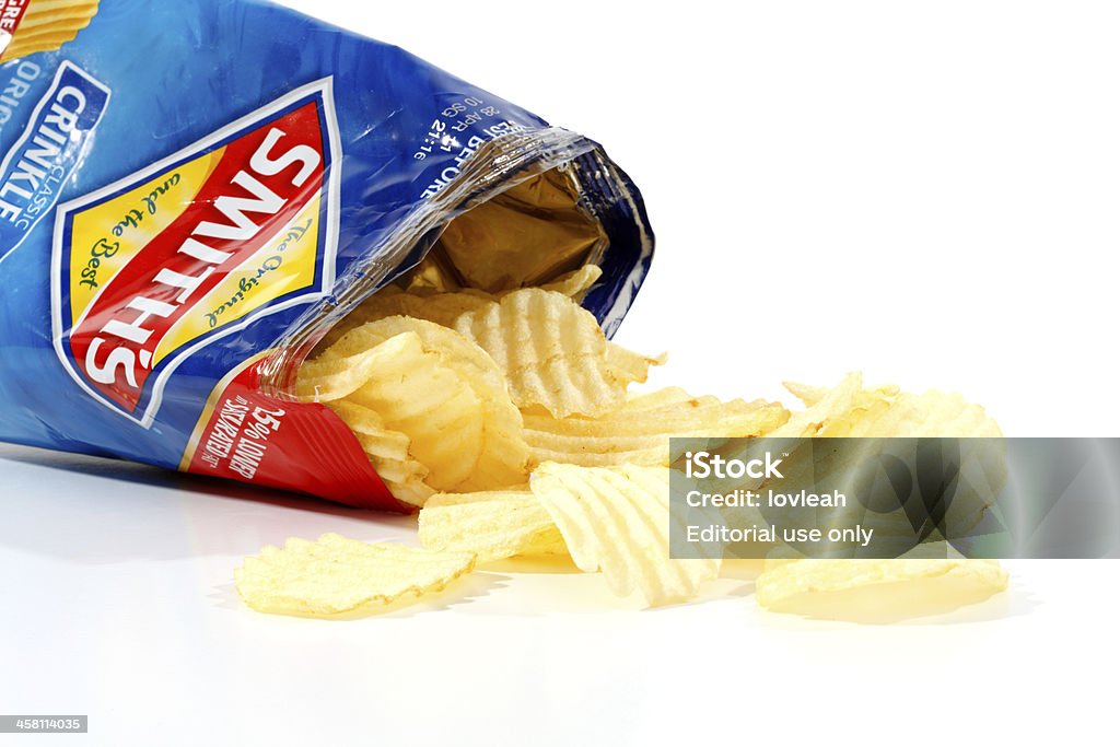 Opened packet potato crisps "Penrith, Australia - February 25, 2011:  An opened 45g packet of Smith\'s Original crisps, with some of the contents spilling out.  Smith\'s Chips are owned by PepsiCo.  Photographed on white studio background." Packaging Stock Photo