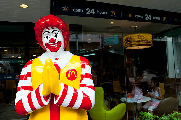 Bangkok, Thailand - September 24, 2011: Ronald McDonald performs a Thai wai greeting outside a 24-hour McDonalds restaurant on Khao San Road.