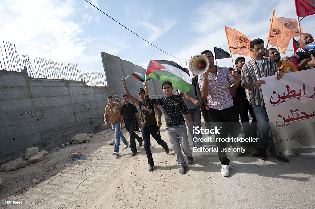 Palestinian Nonviolent Activism "Al-Walaja, Occupied Palestinian Territories - November, 13th, 2010: Palestinians march in a nonviolent protest against the Israeli separation barrier which threatens to encircle the West Bank town of Al-Walaja." Apartheid Stock Photo