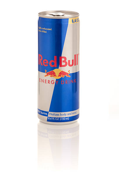 Frederick, MD, USA - February 19, 2011: Product shot of Red Bull Energy Drink, packaged in an 8.4 oz can. Red Bull is an energy drink containing about as much caffeine as a cup of coffee. It is sold by the Austrian Red Bull GmbH. Studio product shot, isolated on white background, with glossy reflection.