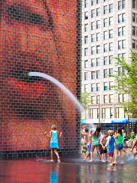 Chicago, Illinois, USA - August 24, 2010: Children playing in the Crown Fountain at Millenium Park