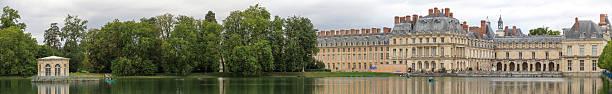Palace of Fontainbleau "Fontainebleau, France - August 5th, 2012 - Panorama of the Palace of Fontainebleau from the lake behind the castle. The shoot was taken during an exposition about Louis XV in 2012" chateau de fontainbleau stock pictures, royalty-free photos & images