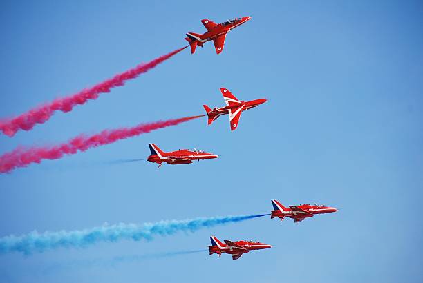 The Red Arrows, Hastings "Hastings, England - July 22, 2012: RAF aerobatic display team The Red Arrows give a display to mark the end of Hastings Pirate Day. It was their first visit to the town in 24 years." british aerospace stock pictures, royalty-free photos & images