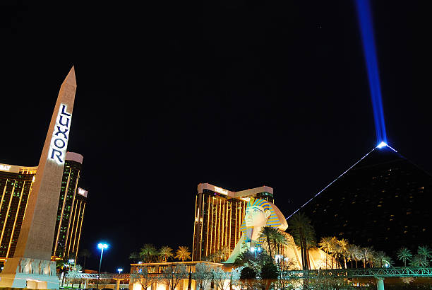 Luxor Hotel Casino, Las Vegas "Las Vegas, Nevada, USA - March 5, 2010: Luxor Hotel with Sphinx statue replica, pyramid, blue light beam and tower at night on Las Vegas Strip as one of the famous landmarks in Las Vegas." las vegas metropolitan area luxor luxor hotel pyramid stock pictures, royalty-free photos & images
