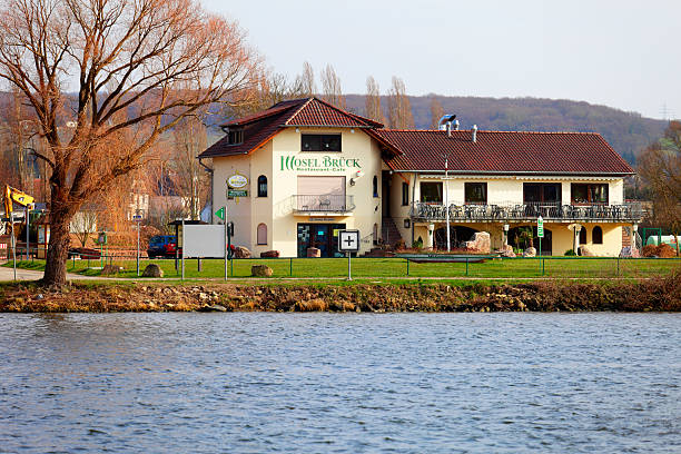 Hotel "Nennig, Germany - March 12, 2011:A small Hotel on the German side of the river Moselle in Nennig, seen from the shore in Remich / Luxembourg." remich stock pictures, royalty-free photos & images