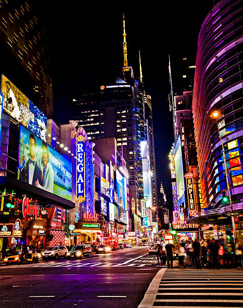 New York Theater District "New York, NY, United States - June 3, 2012: Times Square is a busy tourist intersection of neon art and commerce and is an iconic street of New York City and America" theatre district stock pictures, royalty-free photos & images