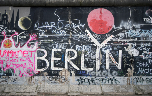 Colorful graffiti drawn on the wall of an abandoned building, during the day - The concept of love