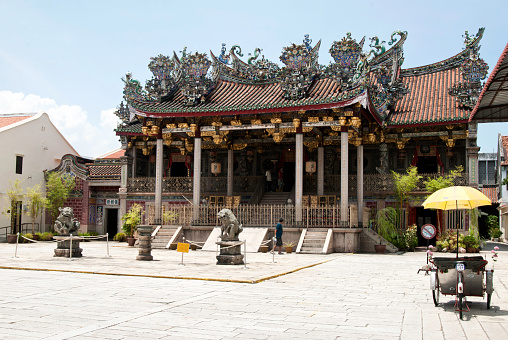 Penang, Malaysia - August 5, 2011: Khoo Kongsi Temple with parked Trishaw to the right.