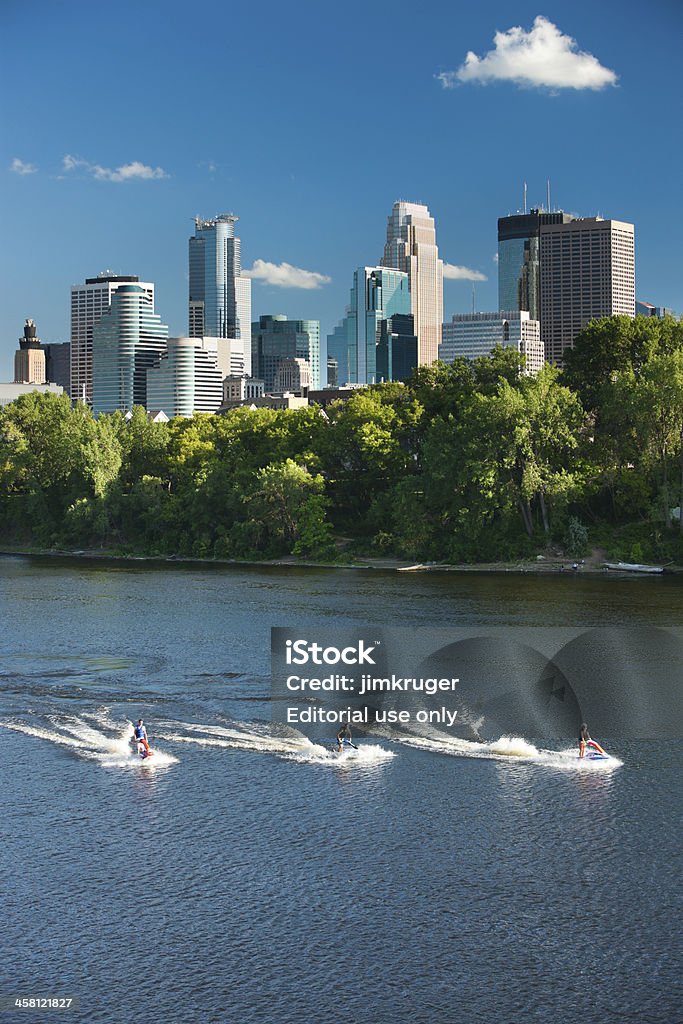 Jet skiers on the Mississippi in Minneapolis, Minnesota. "Minneapolis, Minnesota - July 20, 2010 Jet skiers enjoy a mid-summer day on the Mississippi river with the dramatic Minneapolis skyline as backdrop." Activity Stock Photo