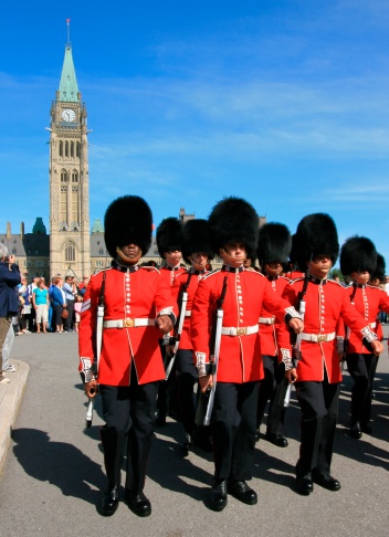 British guards in bearskin hats and red uniforms on parade in London, UK. Changing the guard takes place several times each week and is a very popular tourist destination