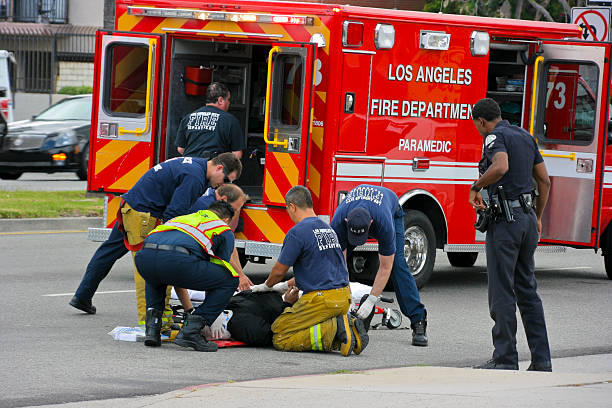 Car Accident "Reseda, USA - May 9,  2011: Firefighters help the victim of car accident on Sherman Way in Reseda, California." police and firemen stock pictures, royalty-free photos & images