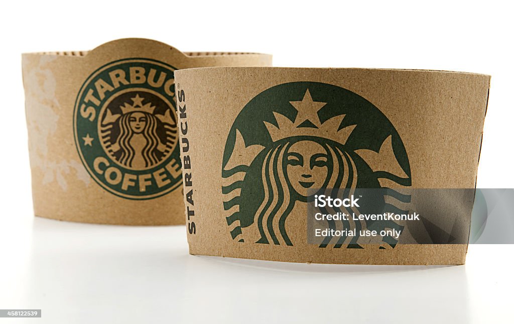New and Old Logos of Starbucks "Ankara, Turkey - May 31, 2012:  Studio shot of a Starbucks coffee cup sleeve with old and new green logos isolated on white background. Starbucks is an international coffee company based in Seattle, Washington.  It is the largest coffeehouse chain in the world, with almost 20 thousand stores in 58 countries" Brand Name Stock Photo