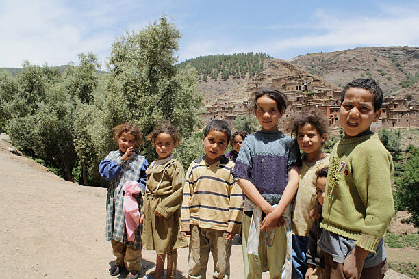 Mountain Children Begging Ouarzazate, Morocco - May, 25 2009: Berber children begging for money near Ouarzazate in the Atlas mountains of Morocco. morocco children stock pictures, royalty-free photos & images