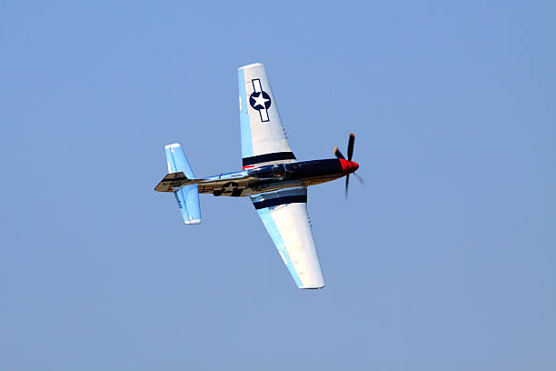 P-51 Mustang "Rochester, New York, United States - July 17, 2011:  WWII era P-51 Mustang, banking in a turn during a flight performance at an airshow in Rochester, New York, on July 17, 2011" p51 mustang stock pictures, royalty-free photos & images