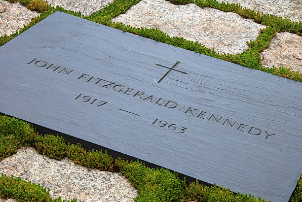 Simple white cross in lawn at Robert Kennedy memorial in Arlington Cemetery