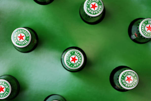Heineken beer "Bucharest, Romania - July 26, 2011: Heineken beer bottles pictured from above. Heineken is a Dutch beer which has been brewed by Heineken International since 1873." opening bottle cap photos stock pictures, royalty-free photos & images