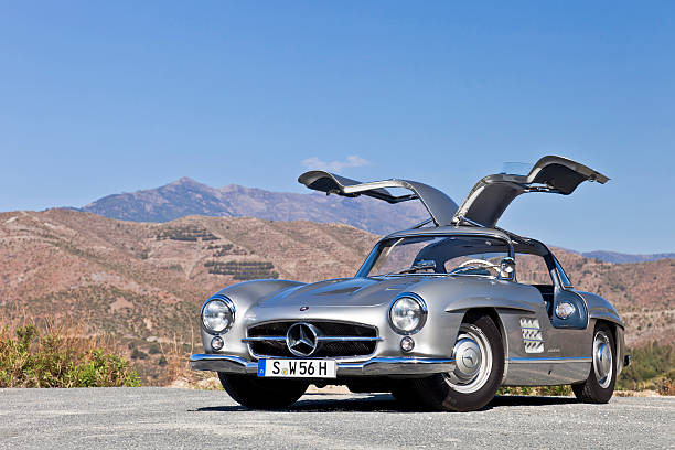 Mercededs 300 SL Gullwing "Marbella, Spain - March, 22nd, 2012: Original Mercedes 300 SL Gullwing from 1957. parked on a cliff by the road in the mountains near Marbella, Spain. Mercedes is celebrating 60 years of SL this year, since the model was first introduced as a race car in 1952." mercedes benz photos stock pictures, royalty-free photos & images
