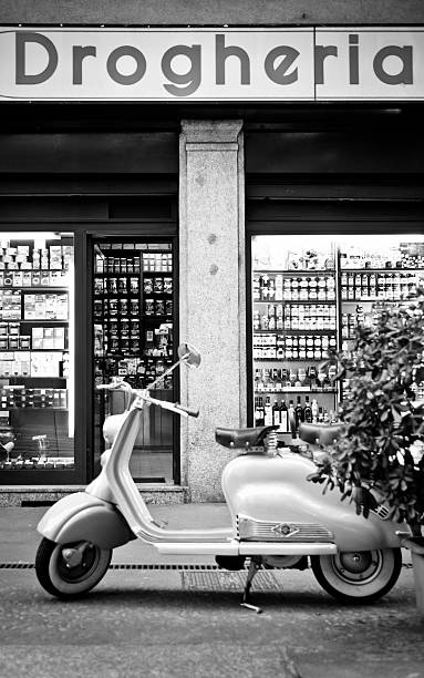 Old Milan "Milan, Italy - April 7, 2012: A parked Lambretta in front of Drogheria Soana. This typical grocery store has been led by Soana family since 1947 in the historical center of Milan." milan photos stock pictures, royalty-free photos & images