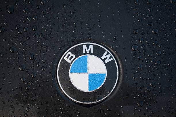 BMW "Padua, Italy - July 6, 2011: Circle shape BMW logo, on a black car covered with dew drops.BMW (Bayerische Motoren Werke) is a German automobile, motorcycle and engine manufacturing company founded in 1916." bmw stock pictures, royalty-free photos & images