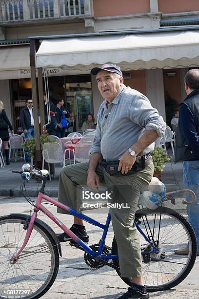 Senior Resting On His Bicycle In Piazza Stock Photo - Download Image Now - Active Lifestyle, Active Seniors, Adult