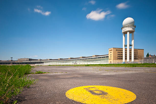 Berlin, Germany - June 5, 2010. The Airport Tempelhof (called the City Airport) is situated in the south-central of Berlin. The terminal (in the background) was constructed in 1927. The airport closed in 2008. In front one of the two parallel runways (9L and 9R), paved with asphalt, is visible. 