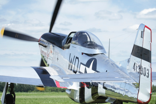 Geneseo, New York, USA - July 12, 2009: The Glamorous Gal, a P-51D Mustang WWII vintage military airplane taxies on a grass runway at the Geneseo Military Air Show.