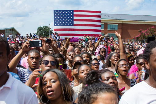 Norfolk, VA, USA - September 4th, 2012: Students cheer and take photos on their cell phones at the 2012 Barack Obama Presidential Campaign Rally at Norfolk State University, a historically black university. 