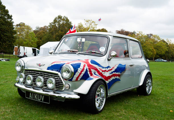 Union Jack Mini car Oxford, England - September 24, 2011: Patriotic Union Jack Mini car parked in a Oxfordshire field. Van with doors open in the background. mini cooper with british flag stock pictures, royalty-free photos & images