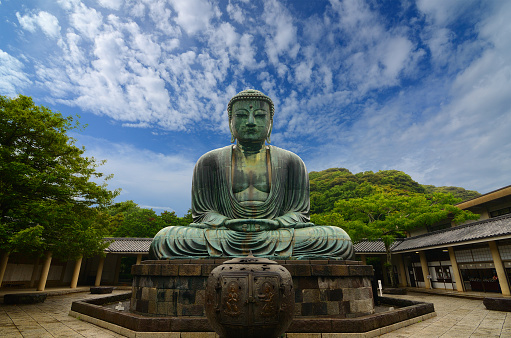 Kamakura, Japan - July 19, 2011: Originally housed in a hall that was destroyed twice in the 14th Century, the great Buddha at Kotoku-in Temple dates from 1252 during the Kamakura Period.