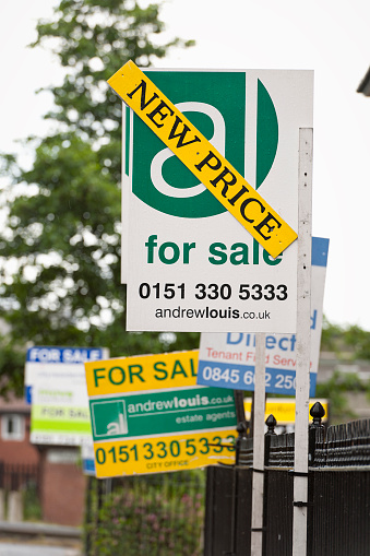 Liverpool, UK - June 16, 2011: Several estate agent signs advertising properties for sale on a residential street in the Toxteth area of Liverpool.