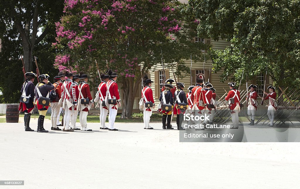 Reenactment of Redcoats Seizing Williamsburg "Williamsburg, Virginia, USA - June 26, 2010: Men in period costume of the 18th Century, stand in formation as they prepare to perform a reenactment of the British Army (Red Coats) as they seize Williamsburg." 18th Century Style Stock Photo