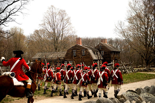Battle Road "Concord, USA - April 16, 2011: British soldiers on Battle Road in Concord, MA during the Commemorating the Patriot Day" concord massachusetts stock pictures, royalty-free photos & images