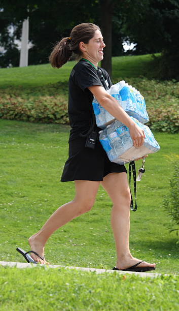 Woman Carrying Water Bottles stock photo