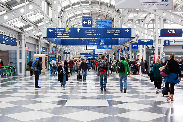 Passengers walking through Chicago O'Hare International Airport stock photo