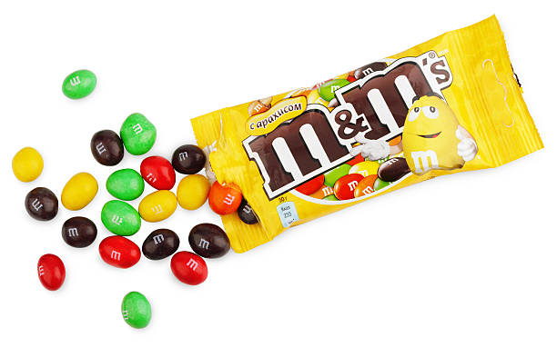 unwrapped M&amp;M's milk chocolate candies Tula, Russia - December 18, 2012: Closeup of unwrapped M+M's milk chocolate candies made by Mars Inc. isolated on white background with clipping path M&M? stock pictures, royalty-free photos & images