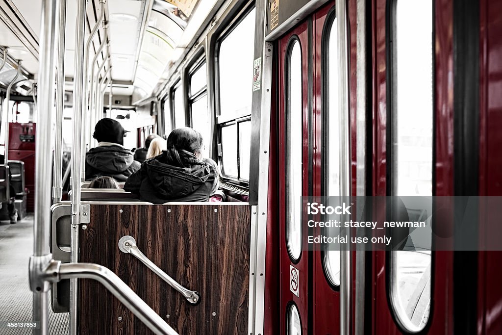 TTC Streetcar Interior, Toronto "Toronto, Canada - March 20, 2011: Toronto Transit Commission Streetcar interior, Toronto. Passenger travelling, viewed from behind." Cable Car Stock Photo