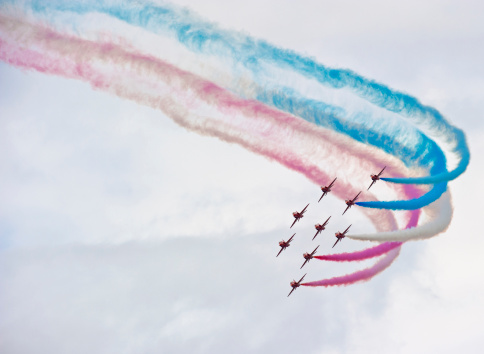 Cosford, UK - June 8, 2014: the Red Arrows air display at RAF Cosford in Shropshire, UK. The red arrows are the aerobatic display team of the British Royal Air Force.