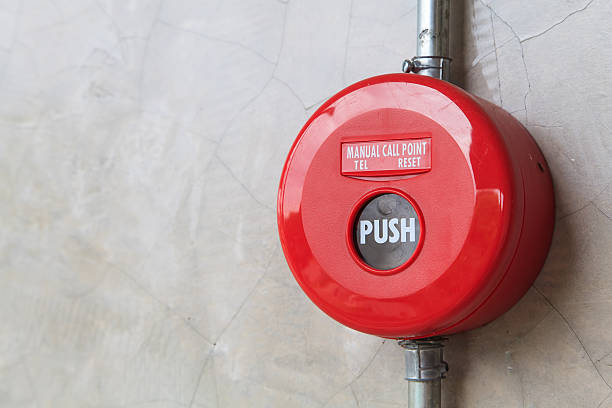 istock Red fire alarm on the concrete wall. 458142039