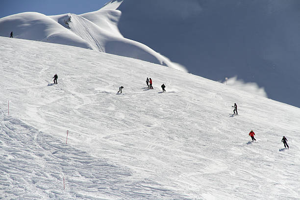 istock Skiers going down the slope at ski resort 458142327