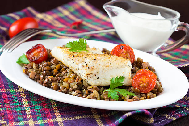 White fish fillet of perch, cod with vegetables and lentils stock photo