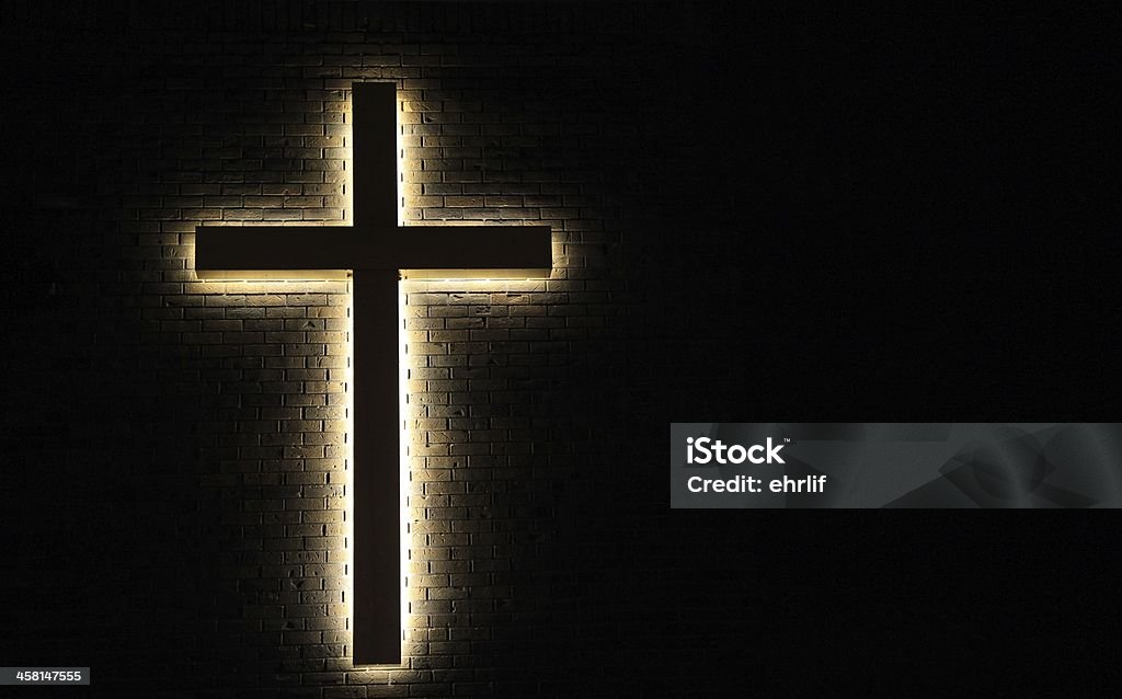 Light of the World Illuminated cross with a brick wall background. God Stock Photo