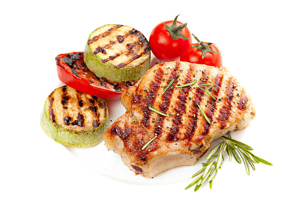 istock Grilled  steak and  vegetables isolated on white background 458147829