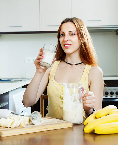 istock girl in yellow drinking milk shake with bananas 458147863