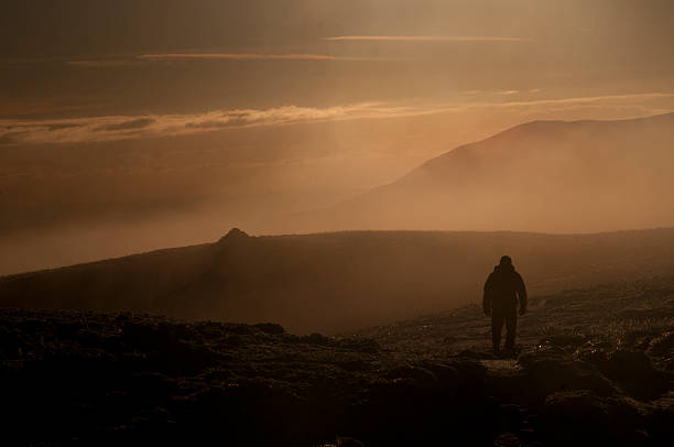 istock Man walking on top of the mountains with mist 458150721