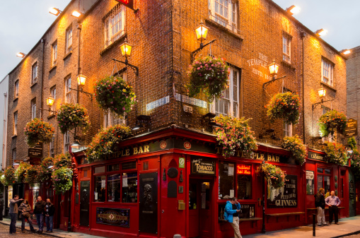 Dublin, Ireland - October 11, 2012: The Temple Bar pub located in district with the same name. With many tourist-focused nightclubs, restaurants and bars, the Temple bar area is the center of Dublin nightlife.