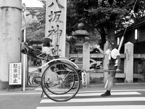 Kyoto, Japan - July 16, 2011:   tourists in rickshaw in the streets of the city of Kyoto